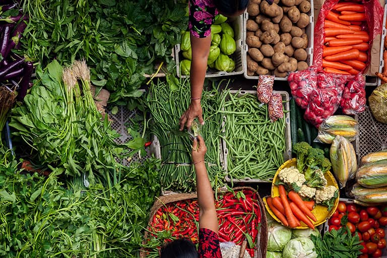 A vibrant market with fruits and vegetables displayed